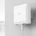 Wall-mounted TP-Link EAP650 D120-Outdoor Access Point with cable connection and green LED indicator.