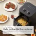 Kitchen view of Oraimo SmartAirFryer with 5L basket filled with fries surrounded by plates of steak, chicken, and sandwiches.