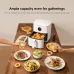 Dining table view of Xiaomi Air Fryer 6.5L with roasted chicken and multiple dishes prepared for family gathering.