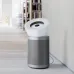 Side view of Dyson BP06 Air Purifier on wooden floor beside desk in organized home office setup.
