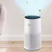 Home setting view of Philips 1000i Series Air Purifier showing blue-lit panel and illustrated clean air flow.