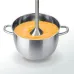 Close‑up view of the Panasonic MX-SS1 3-in-1 Hand Blender blending soup inside a metal pot with an immersion shaft.