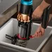 Angled view of Dyson V16 Piston Vacuum Cleaner dustbin being emptied via red lever into sink for hygienic disposal.