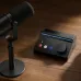 Desk setup view of the BOYA Caster X1 Audio Interface connected to a microphone for desktop audio recording.