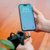 Hand connecting a black braided Verbatim SCC2-CC60 cable to a smartphone.