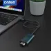 Angled desk view of the Onten OTN-UC982 Type-C Male to 8K HDMI Male Adapter connected to a laptop beside workspace accessories.
