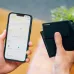 Person tracking a black Verbatim My Finder Card in a wallet using a smartphone.
