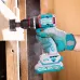 Action shot of TOTAL TDLI205582 Drill Machine boring a hole in wood with hole saw bit and visible sawdust spray.