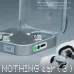 Angled view of black and silver Nothing Ear (3) earbuds in transparent cases highlighting wireless charging and battery life.
