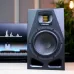 Front view of the ADAM Audio A7V Studio Monitor Speaker placed on a desk with its woofer and ribbon tweeter visible.