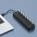 Angled desk view of the Onten OTN-5307 7-in-1 USB Hub connected to a laptop, showing multiple USB ports in a slim hub design.