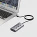 Angled desk view of the Onten OTN-8108 7-in-1 USB Hub connected to a laptop, showing multiple ports in a compact hub design.