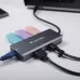 Top view of a gray Verbatim Essentials 6-in-1 hub with various cables connected.