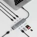 Top view of the WiWU Travel Wi‑HB001 8‑in‑1 Type‑C Hub connected to a laptop with multiple cables, cards, and devices attached.