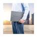 Image of a person holding the gray Bwoo CB43-G bumper sleeve case against their hip, outdoors.