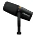 Angled view of the black Shure MV7 Plus broadcast microphone on a stand, showing the colored LED strip.