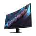 Angled view of curved Gigabyte GS27QCA Monitor showing illuminated GAMING text with vibrant red and blue effects.