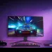 The LG UltraGear 27GS95QE-B OLED monitor displaying a bright sports car game on a desk with a keyboard, controller, and purple lighting.