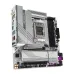 Angled view of B650M AORUS Elite AX ICE showing rear I/O, VRM heatsinks, RAM slots, and PCIe expansion slot