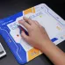 Close-up of hand using mouse on Inphic PD60 Gaming Mouse Pad with futuristic geometric design and printed text.
