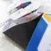 Close-up of Inphic PD900 Gaming Mouse Pad with white gaming mouse, showing angular design and textured underside grip.