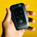 Handheld view of the Jio MF680s SIM Supported 4G LTE Mobile Wi-Fi Pocket Router showing its compact design and front panel.