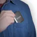 A person placing the Transcend ESD420C Magnetic Portable SSD into the pocket of a denim shirt, highlighting its compact and portable design.