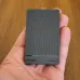 Compact UGREEN portable SSD held in hand with textured finish, showcasing sleek design and 20Gbps 1TB storage