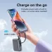 Hand holding a phone charging from a gray power bank via its built-in USB-C cable. Text: 
