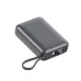 A compact, matte gray power bank with a digital battery percentage display, built-in lanyard, and multiple USB-C and USB-A charging ports on the front.