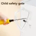 A small hand with a screwdriver attempts to insert it into a socket on a white power strip, highlighting the child safety gate.