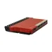 Angled view of Mikrotik L009UiGS-RM Router with visible ports, power input, and black heat sink structure.