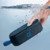 A hand holds the Soundcore Select 3 speaker underwater, demonstrating its water-resistant capabilities.