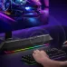 Havit SK772BT Portable Bluetooth Speaker placed below a monitor in a gaming setup with RGB lights visible.