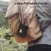 A Monster Cube 1 Portable Bluetooth Speaker hangs on a backpack outdoors, showing its compact and ultra‑portable design.