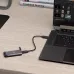 A EX100U external SSD and USB cable connected to a laptop on a wooden desk, with books in the background.