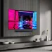 A wall-mounted Samsung 77S90D TV and soundbar display a neon-lit wakeboarder against a dark background.