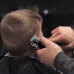 Action view of Kemei KM-1113 Hair Trimmer used by barber to cut short hair with precision.