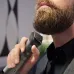 Close-up of Philips MG7920/15 Trimmer in use on thick beard with green light indicator and ergonomic black handle design.