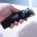 Lifestyle view of Xiaomi Mi IPX7 Trimmer being rinsed under running water, highlighting waterproof and easy-clean design.