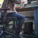Workspace view of HP Z2 Tower G1i Workstation placed under desk with monitor, keyboard, and user working in office.