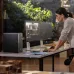 Workspace view of HP Z2 SFF G1i Workstation tower beside dual monitors showing architectural design and coding apps.
